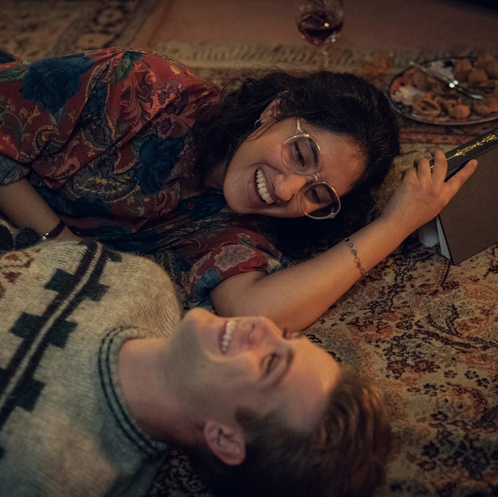 two individuals lying on the floor sharing a moment while holding hands two individuals lying on the floor sharing a moment while holding hands