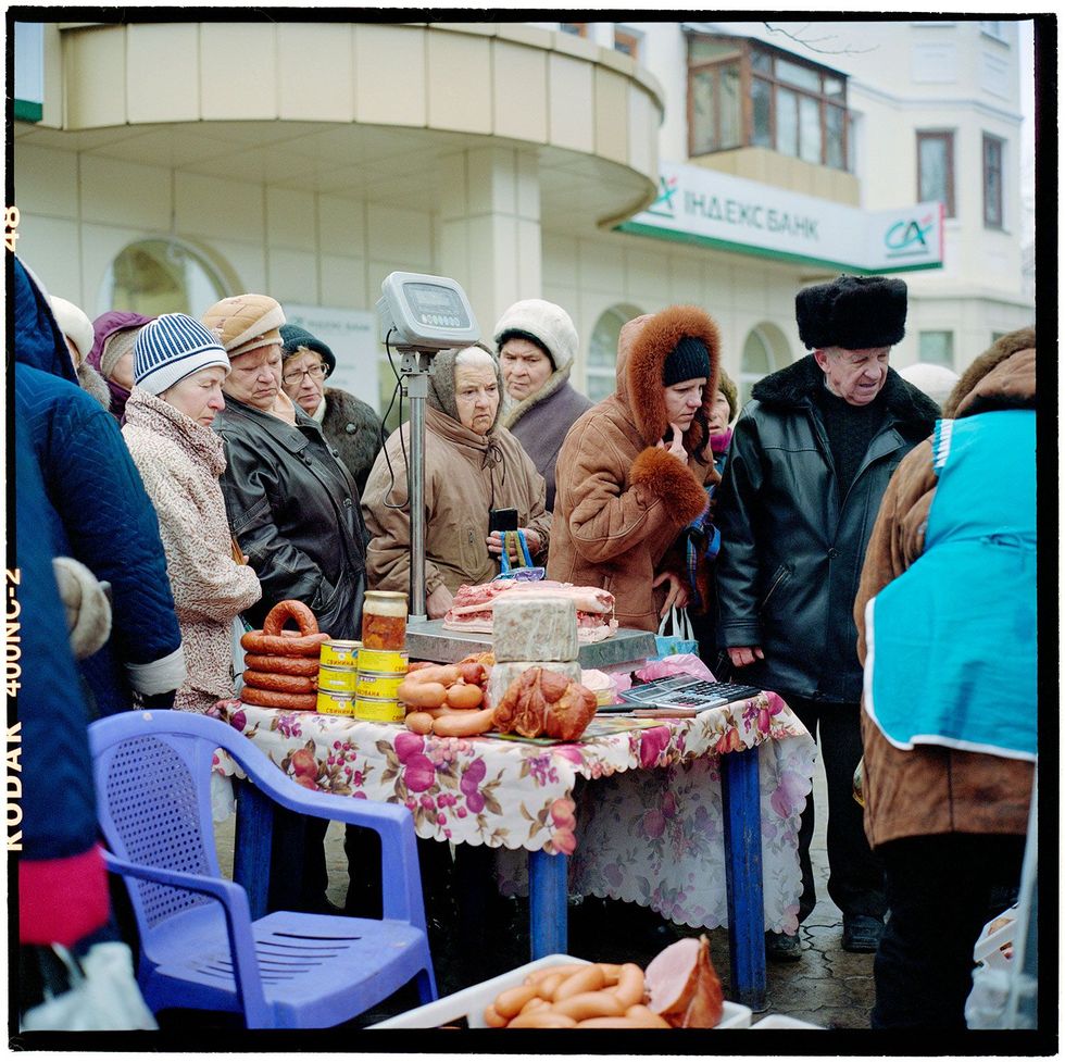 2007 DonetskOp een regenachtige dag op de markt in het westen van Donetsk slijten straatverkopers hun waren waaronder ingemaakte groenten verse vis en zoals hier vlees