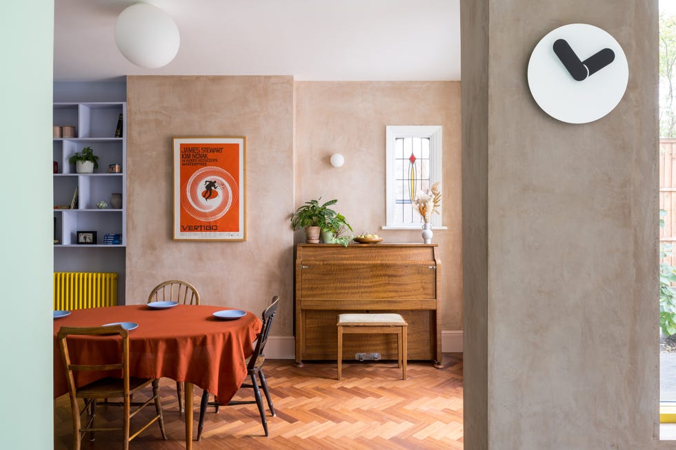 a room with a table and chairs dining room wooden floor plaster walls modern edwardian property hackney