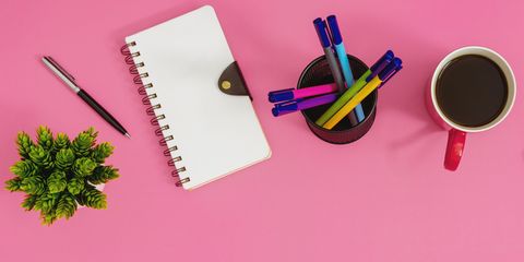 office supply items on pink background