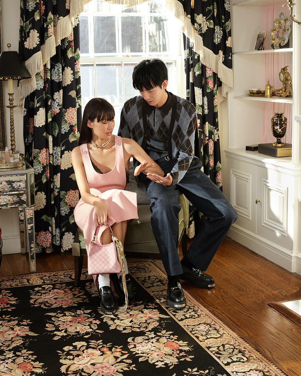 a young couple seated together showcasing their outfits and accessories