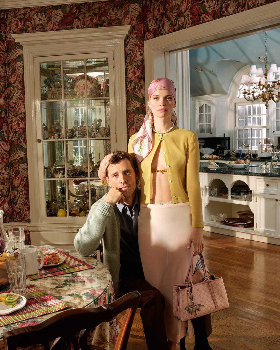 a woman posing with a man in a domestic setting
