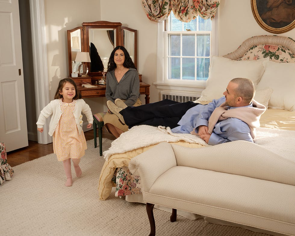 indoor scene featuring family members in a bedroom setting