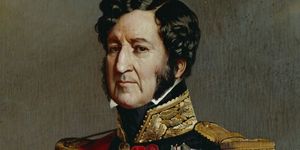 louis philippe portrait, he wears a black military uniform with gold, red, and white accents