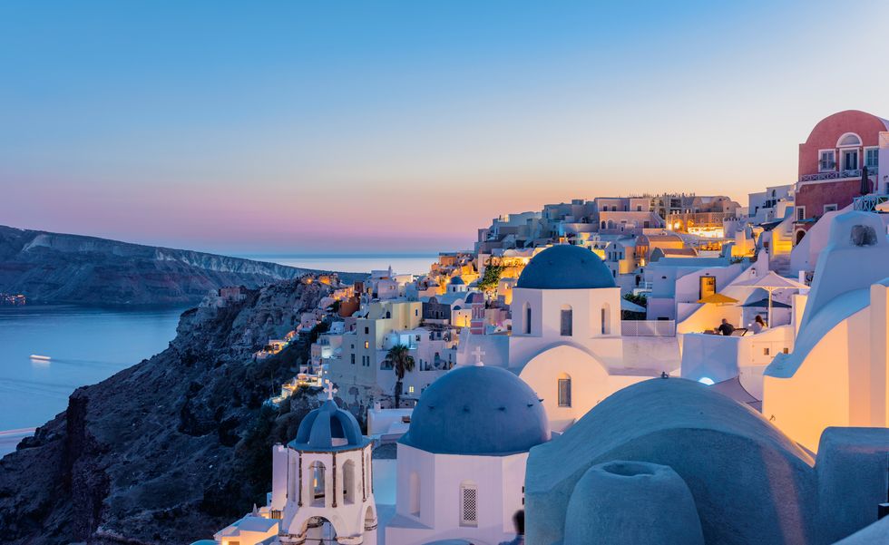 oia, santorini island, cyclades, greece twilight, houses and churches after sunset