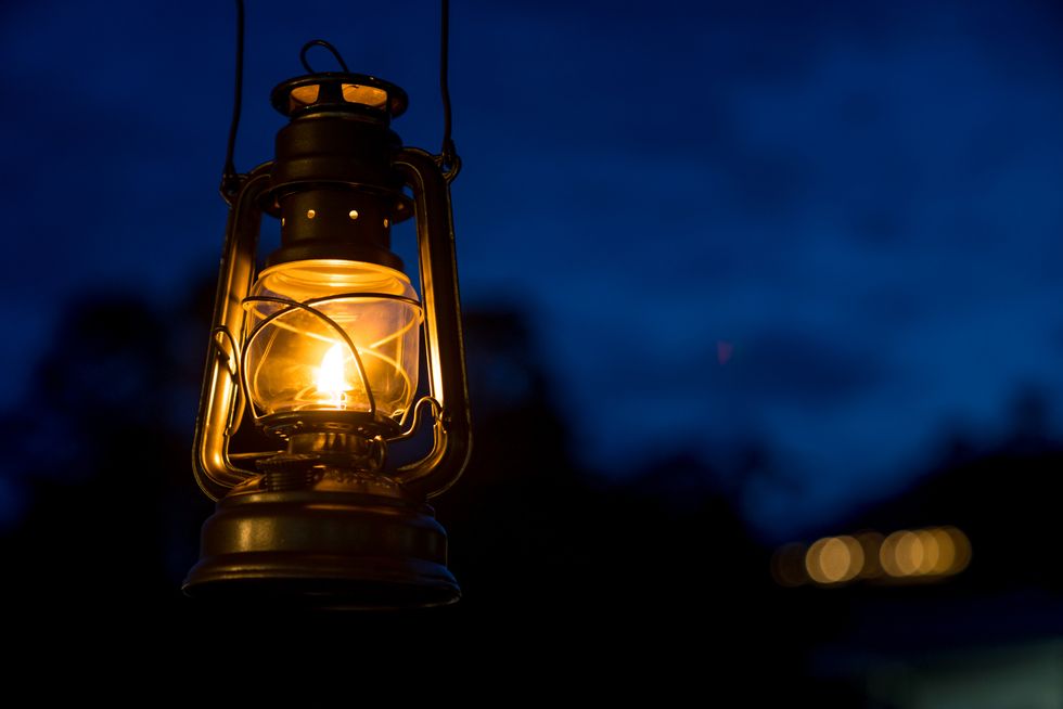 oil lamp lighting up the darkness or burning kerosene lamp background, camping  light concept