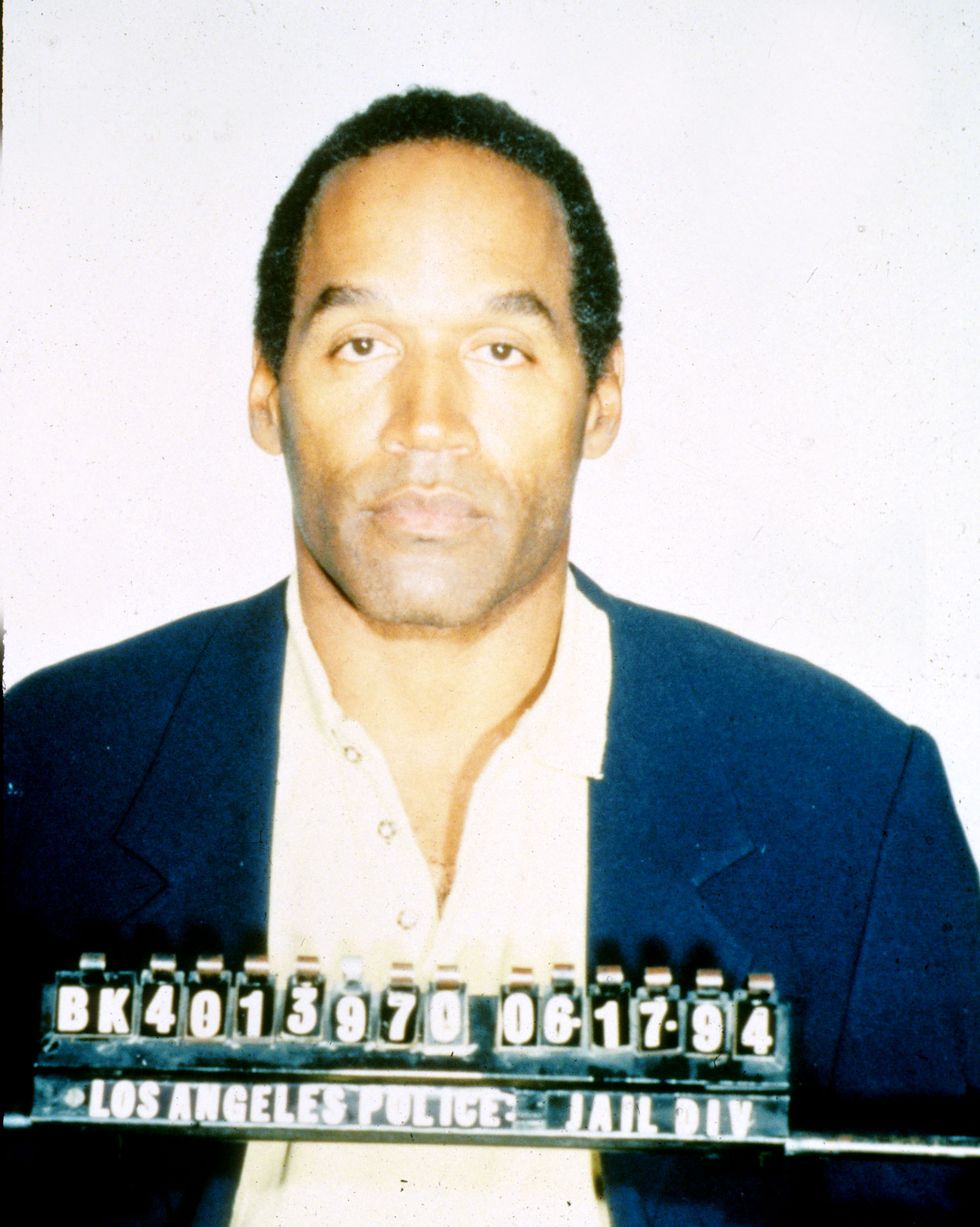oj simpson stares at the camera with police identification numbers in front of him