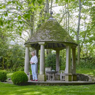 cotswolds home of oka cofounder sue jones a stone tiled gazebo provides shelter from the sun and a cozy place to sit in the evenings