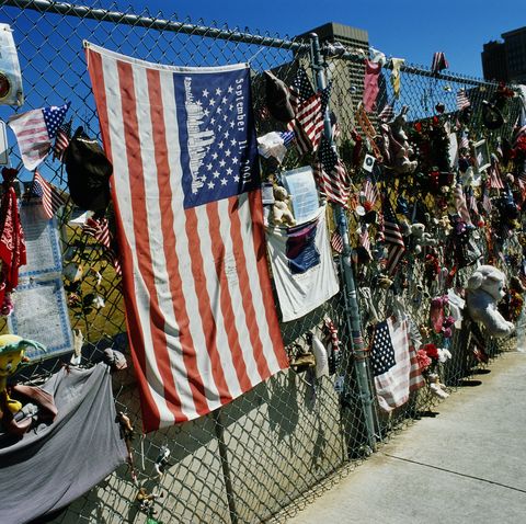 the chain link fence along the west side of the oklahoma city national monument is covered with an american flag and various items left by people in memory of the bombing of the alfred murrah federal building on april 19, 1995, which killed 169 people
