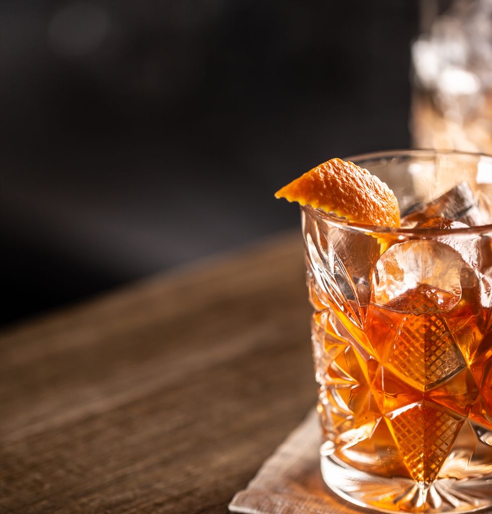 old fashioned whiskey drink on ice with orange zest garnish