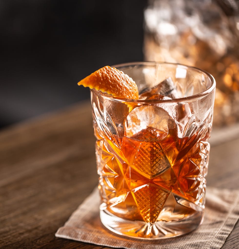 old fashioned whiskey drink on ice with orange zest garnish