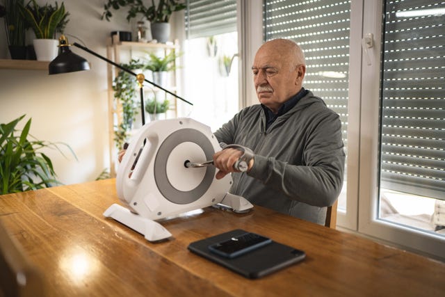 old man exercises arms