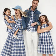 family in matching blue and white gingham outfits