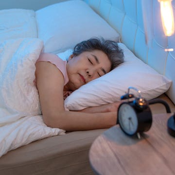 older woman lying on the bed