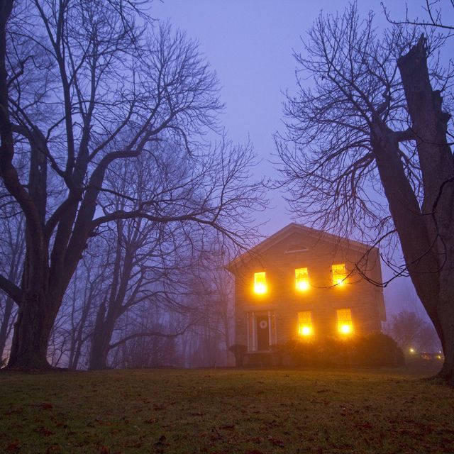 Old stone house on foggy night