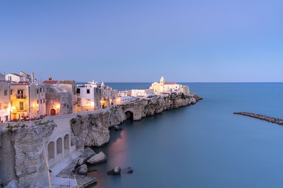 old town of vieste by sea at dusk, puglia, italy