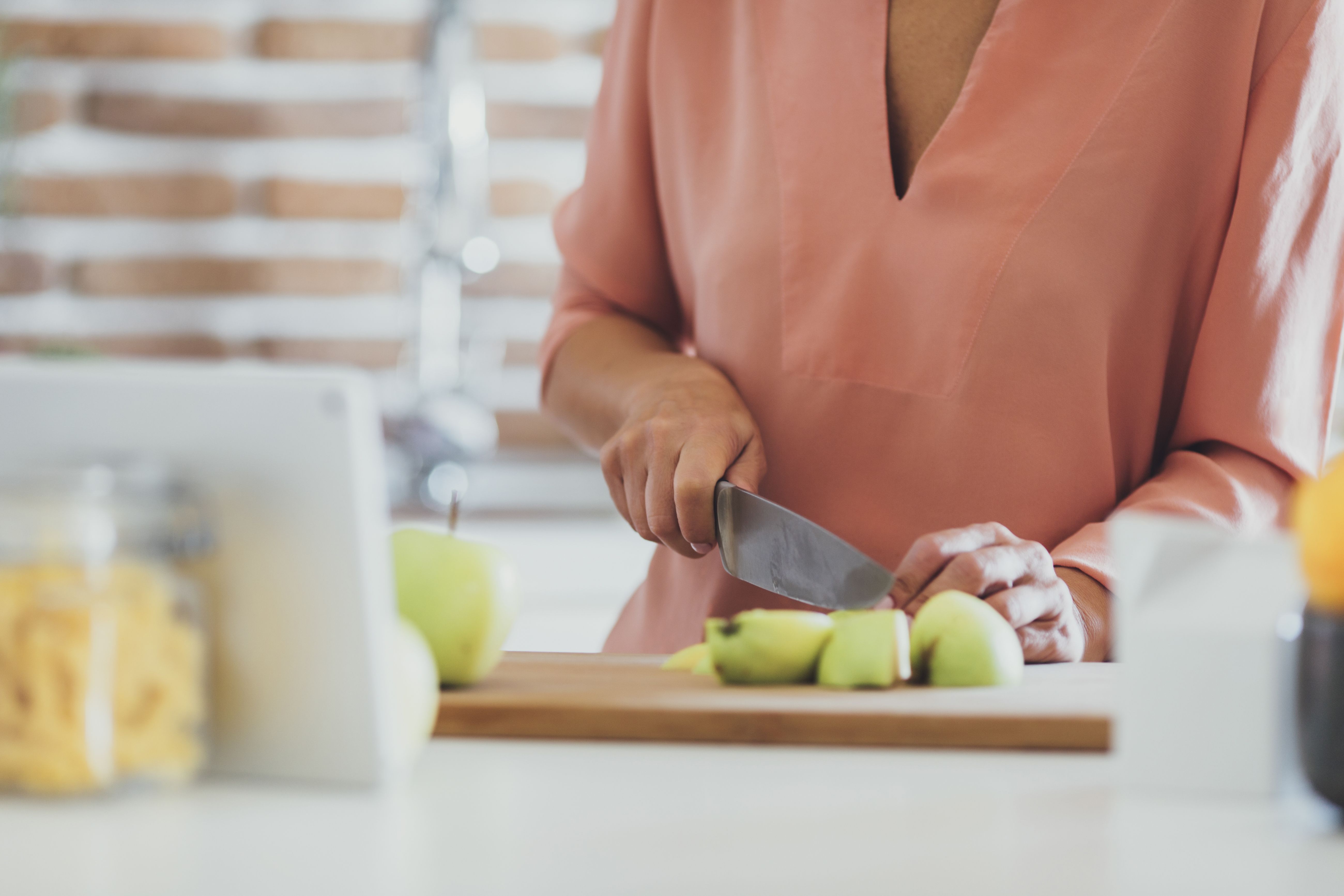 https://hips.hearstapps.com/hmg-prod/images/older-caucasian-woman-cutting-apples-in-kitchen-royalty-free-image-605763063-1541705762.jpg