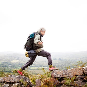 older woman trekking in the mountains of ireland