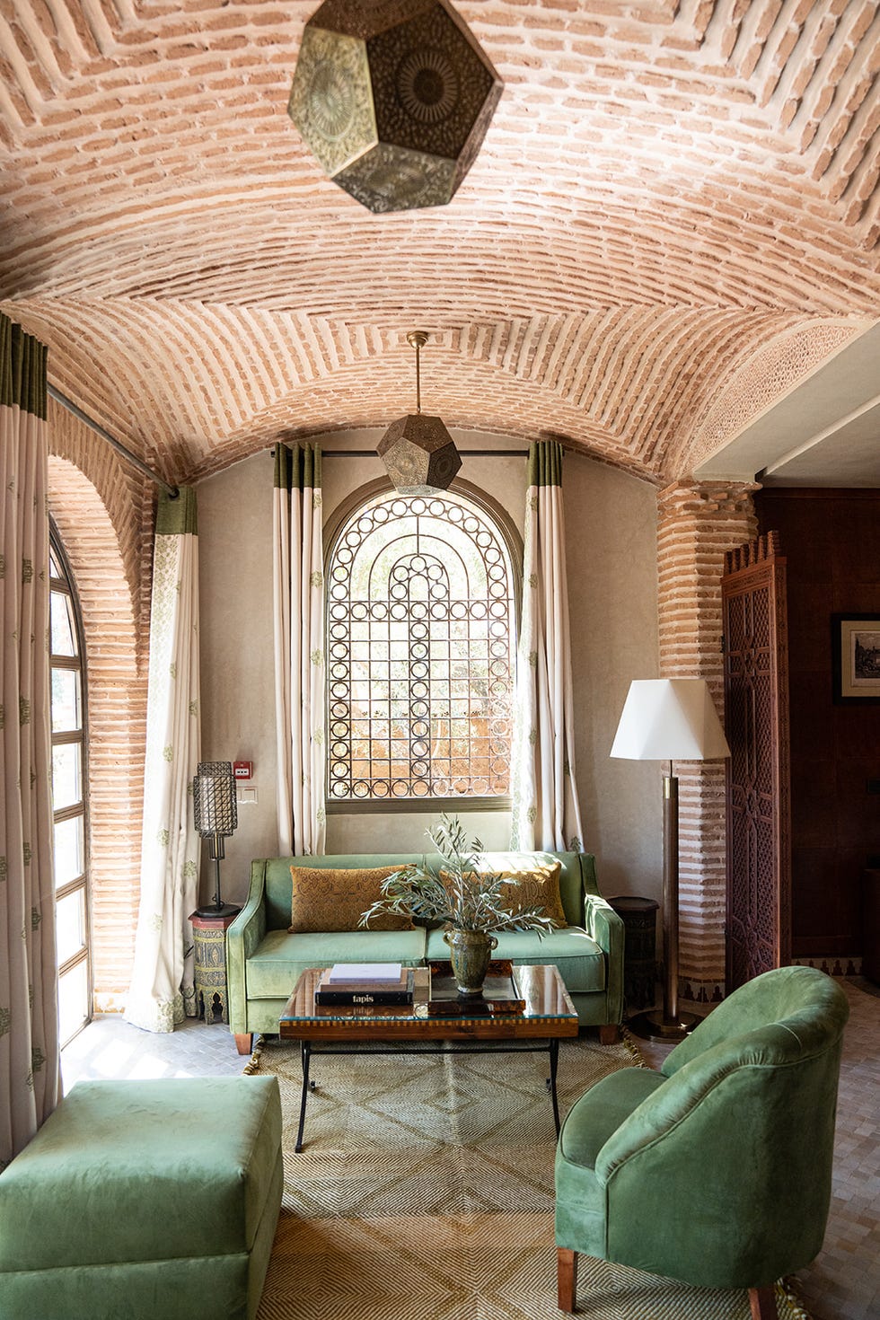 a room with a couch and a table with a lamp on it