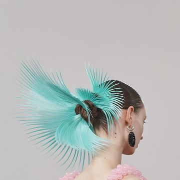 a person with a blue feathered headdress