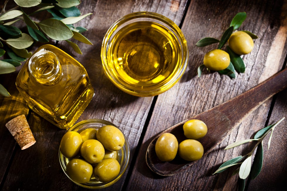 Olive oil and green olives shot from above