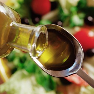 olive oil pouring on to a spoon