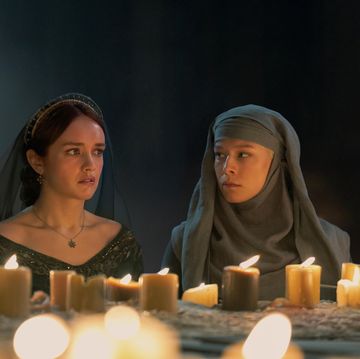a couple of women sitting at a table with candles