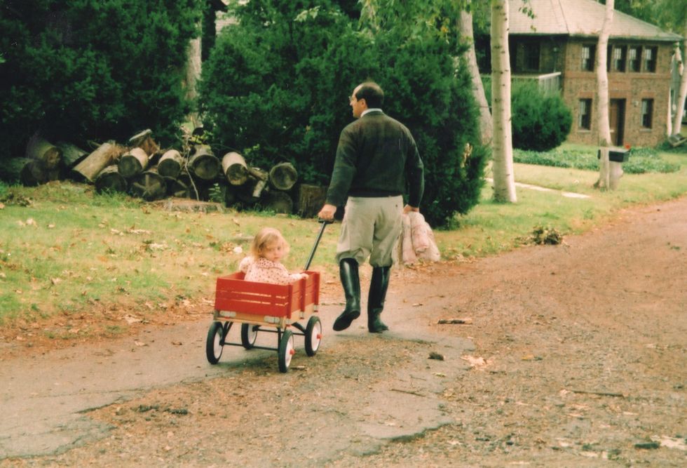 a young girl is pulled in a wagon