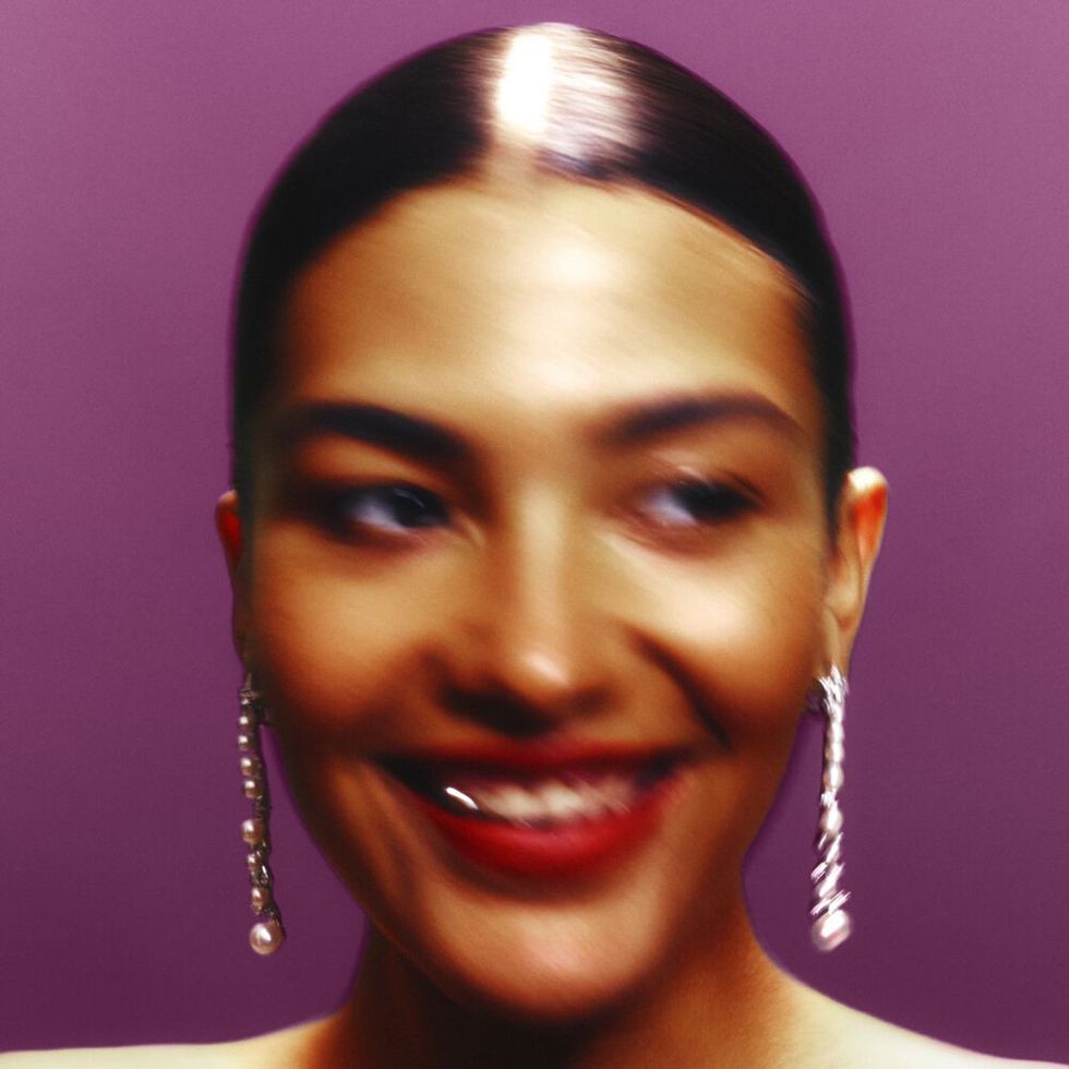 olivia dean album cover featuring olivia dean smiling and wearing dangly earrings