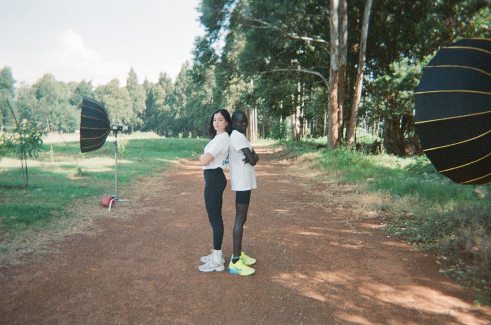 two women standing on a dirt path