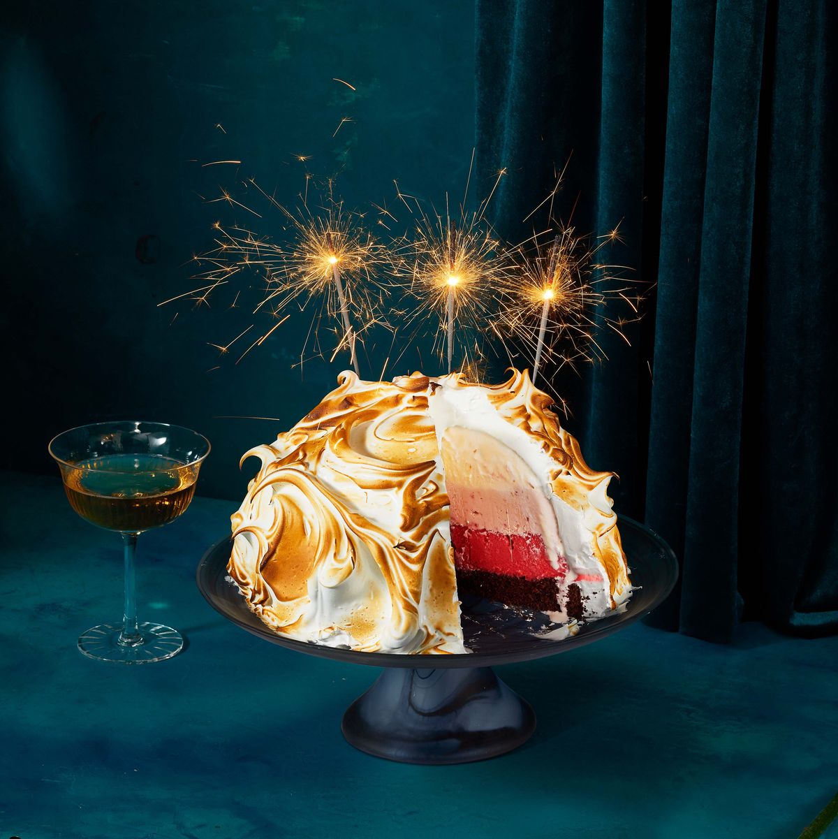 ombré baked alaska cake with ice cream in the center and sparklers on top