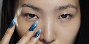a woman with blue nail polish
