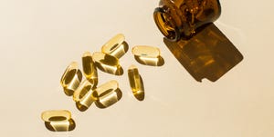 omega 3 fish oil capsules and a glass bottle on a beige background