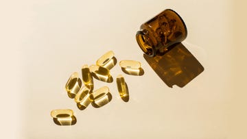 omega 3 fish oil capsules and a glass bottle on a beige background