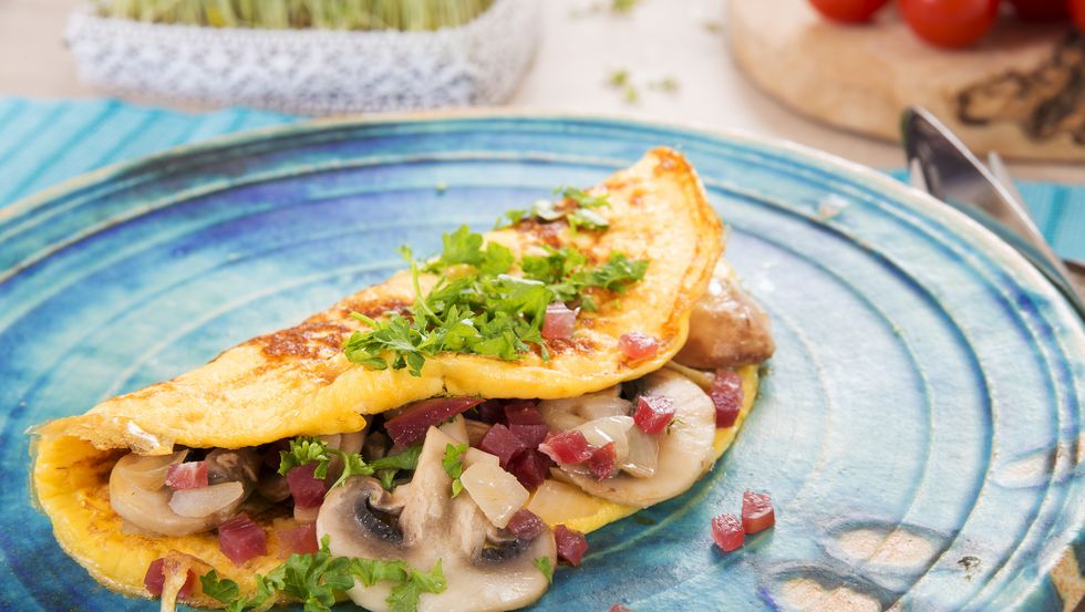 Omelette with champignon, onion and ham on plate
