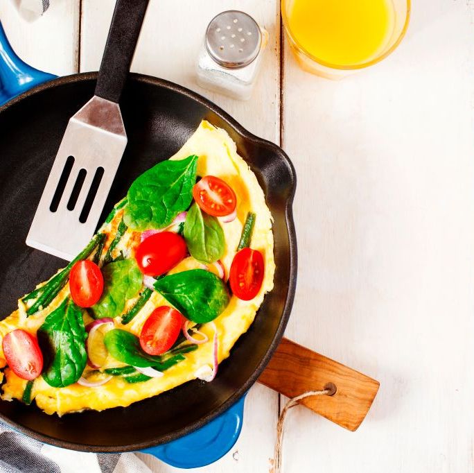 omelette with green bean spinach and tomato in a skillet top view