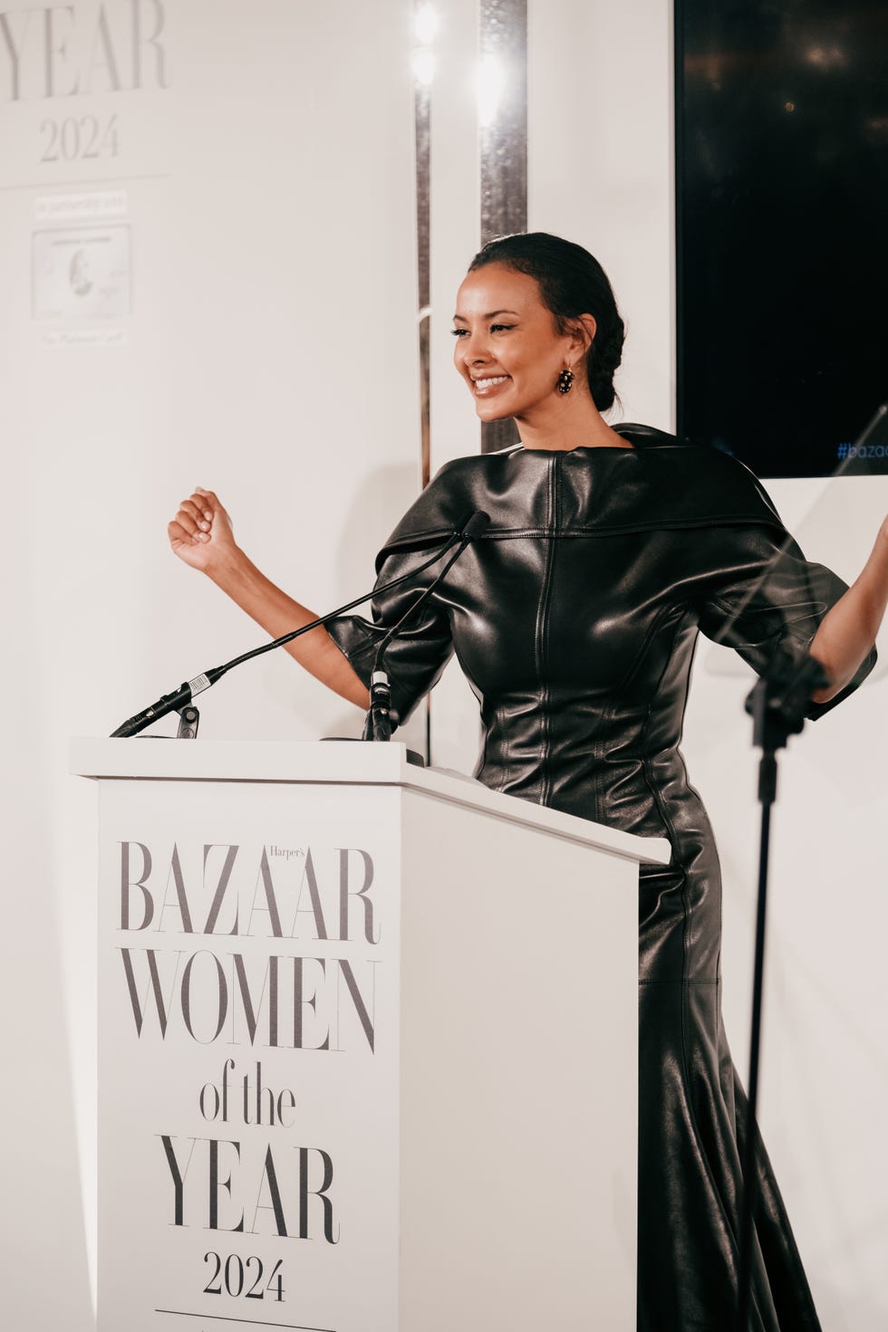 awards ceremony podium with speaker in a black leather dress