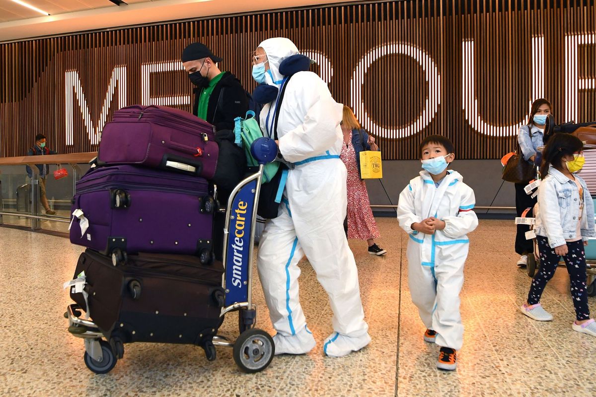 topshot   international travellers wearing personal protective equipment ppe arrive at melbourne's tullamarine airport on november 29, 2021 as australia records it's first cases of the omicron variant of covid 19 photo by william west  afp photo by william westafp via getty images
