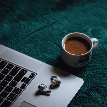 a cup of coffee on a laptop