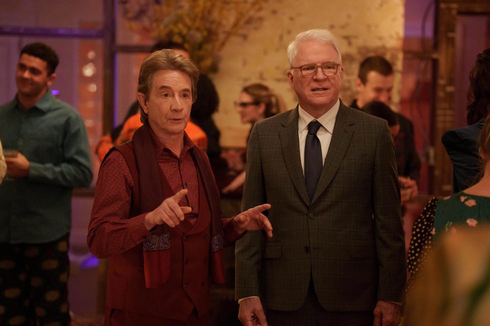 only murders in the building “the tell” episode 205 mabel hosts a party for an eclectic art crowd which also serves a double purpose for smoking out a liar in the trio’s midst. oliver relies on a party game and an era which he feels brings the best out in him to uncover the truth and any potential psycho killer. oliver (martin short) and charles (steve martin), shown. (photo by: craig blankenhorn/hulu)