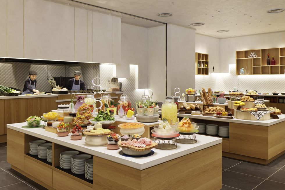 a kitchen with many cakes on the counter