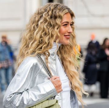 new york, new york february 12 emili sindlev wears silver jacket, pants with ny print, turtleneck, green bag outside coach on february 12, 2024 in new york city photo by christian vieriggetty images