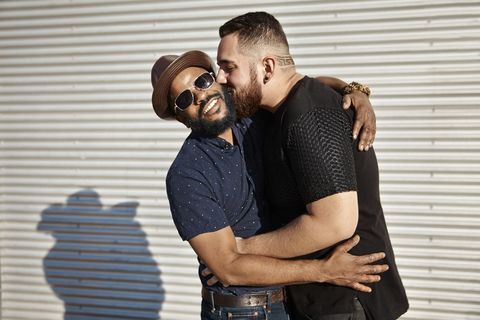 one man kissing another man's cheek