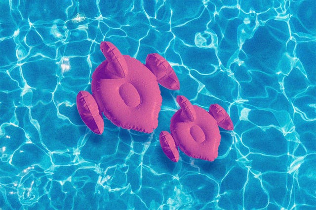 large and small flamingo pool float in water