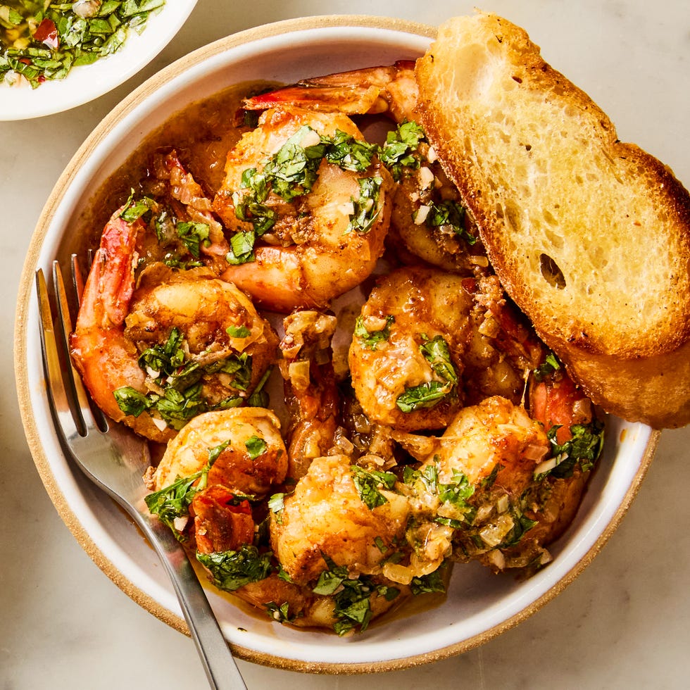 for this under 30 minute one pan dinner, cumin and coriander marinated shrimp are cooked with shallots, topped with a parsley, cilantro, and oregano based chimichurri sauce, and served with crusty bread