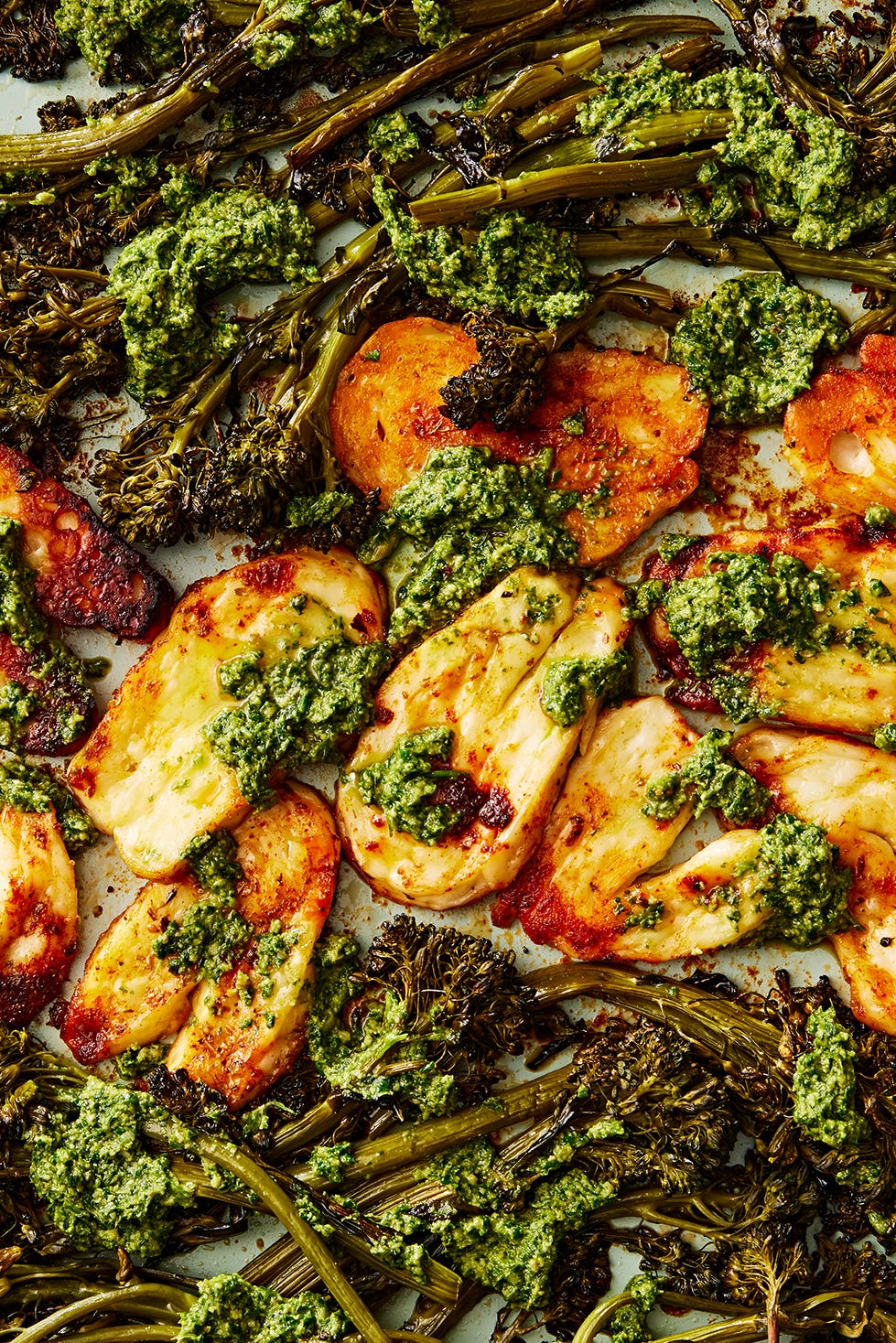 One Pan Roasted Halloumi & Broccolini roasted halloumi and broccolini with a pesto sauce on a sheet pan