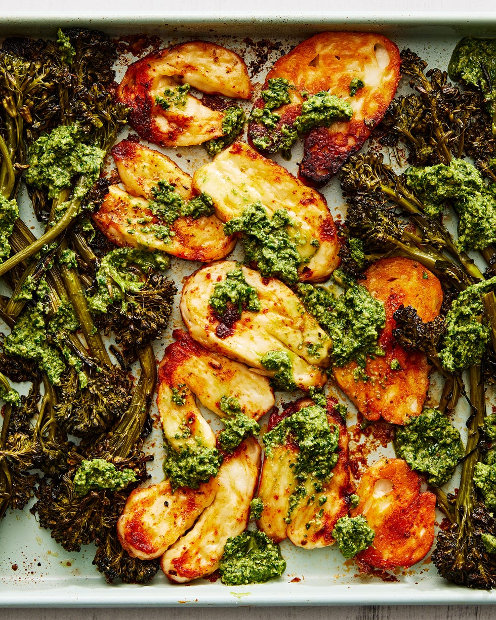 roasted halloumi and broccolini with a pesto sauce on a sheet pan