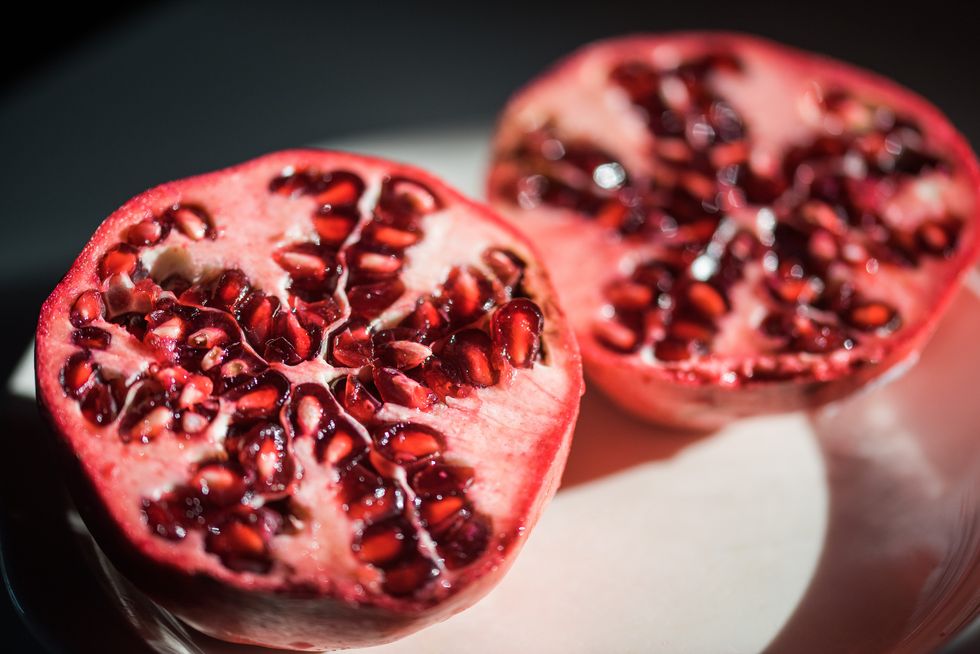 one pomegranate cut in half