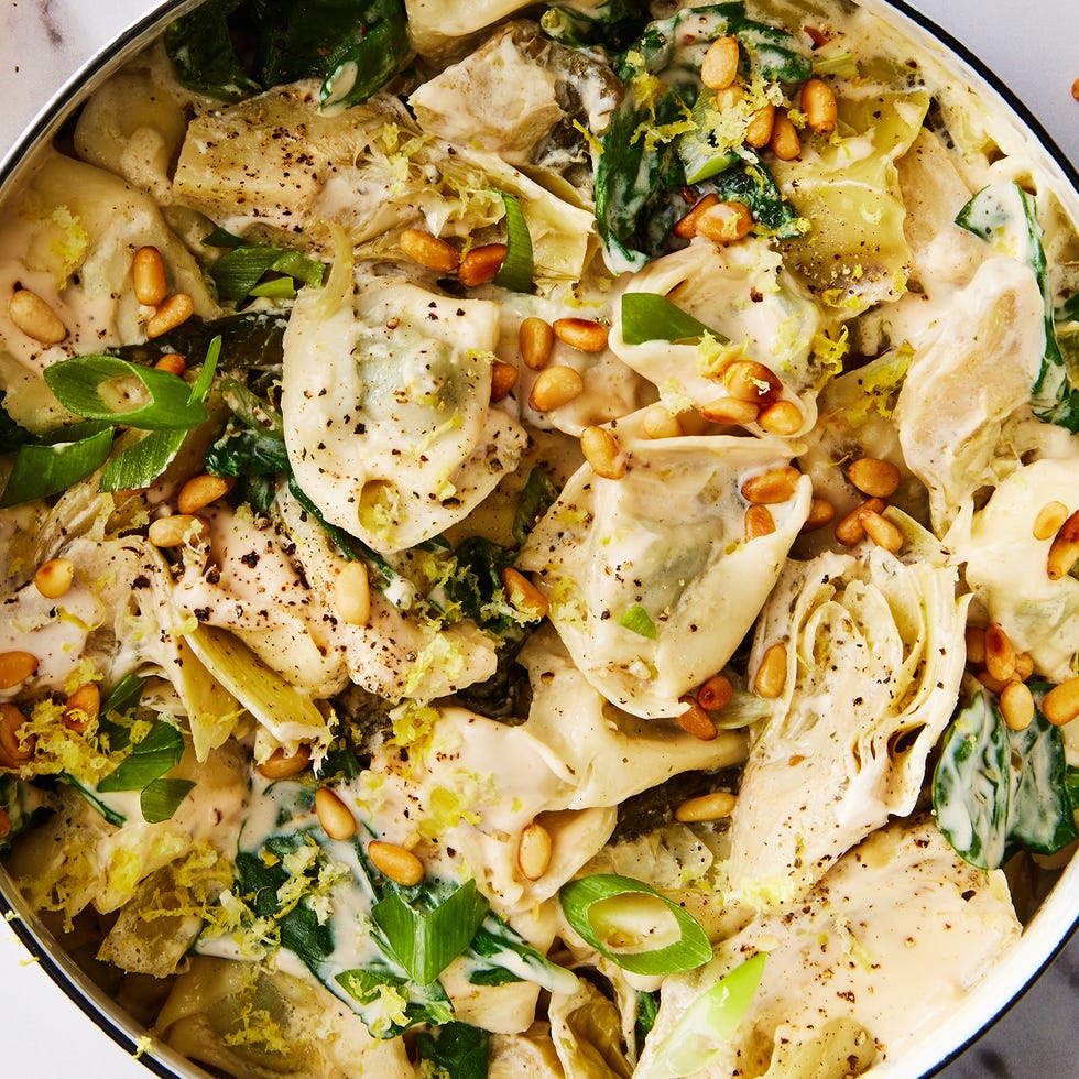 creamy tortellini with artichokes, spinach, kale, and toasted pine nuts