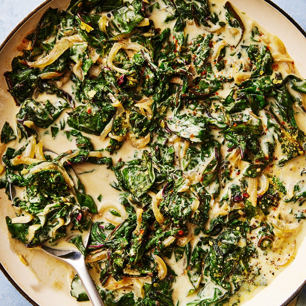 greens and onions in a creamy sauce in a pan